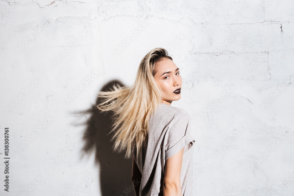 Fototapeta premium Portrait of sensual blonde young woman with black lipstick
