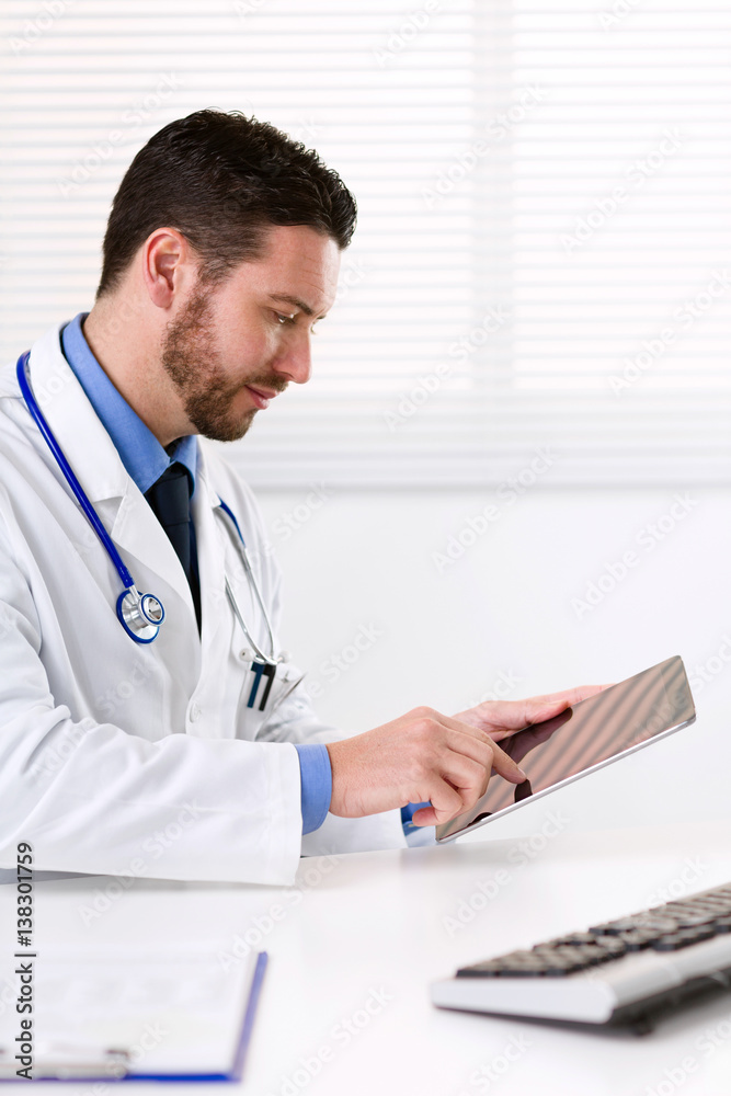 Male doctor using tablet Male doctor using tablet