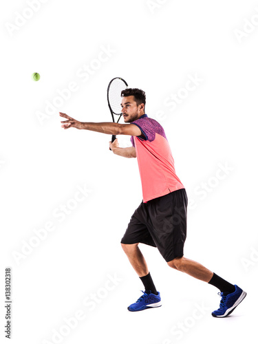 Young man is playing tennis © takoburito