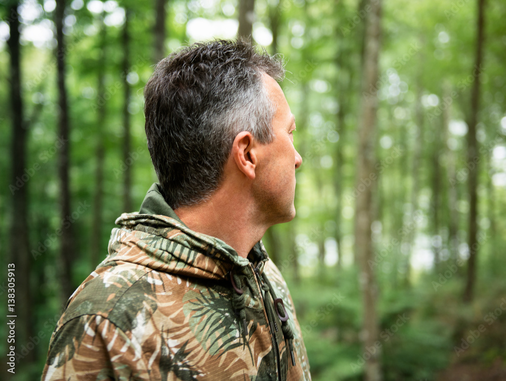 Outdoor autumn male portrait. Handsome middle-aged man posing in forest, image toned and noise added. Outdoor autumn male portrait. Handsome middle-aged man posing in forest, image toned and noise added.