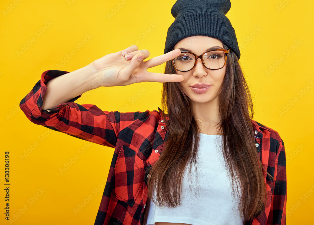 Young woman posing over yellow background. Emotional female