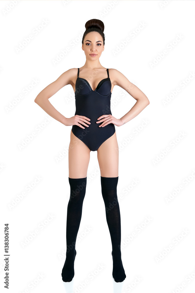 Fototapeta premium Portrait of beautiful woman, full length. Attractive girl with perfect body posing at studio over white background with copy space.