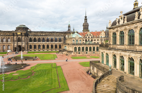 DRESDEN, GERMANY - JULY 2016: Dresdner Zwinger palace is designed by Poeppelmann in 1710 as orangery and exhibition gallery. Tourists walk and visit the beautiful palace in a cloudy day