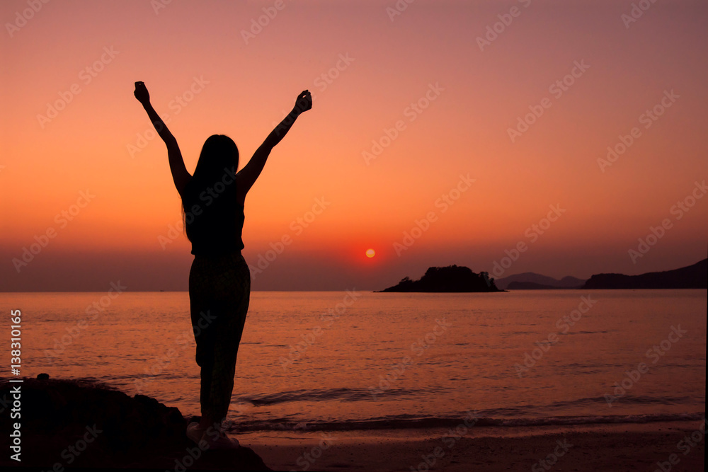 Silhouette of happy Woman in Sunrise