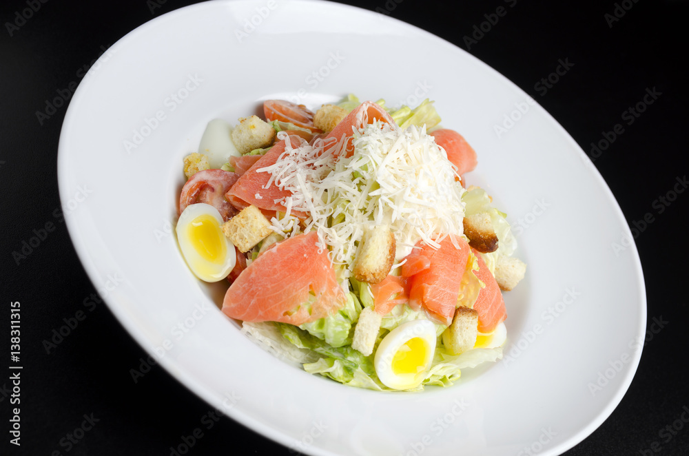 Salad with marinated salmon on a white plate Salad with marinated salmon on a white plate