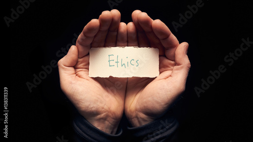 Hands holding a Business Ethics Concept