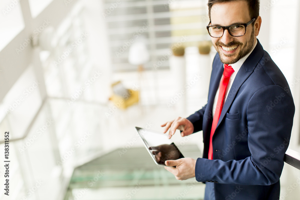 Handsome businessman using tablet in office Handsome businessman using tablet in office