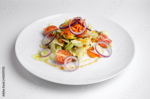 Thai salad with beef and vegetables on a white plate