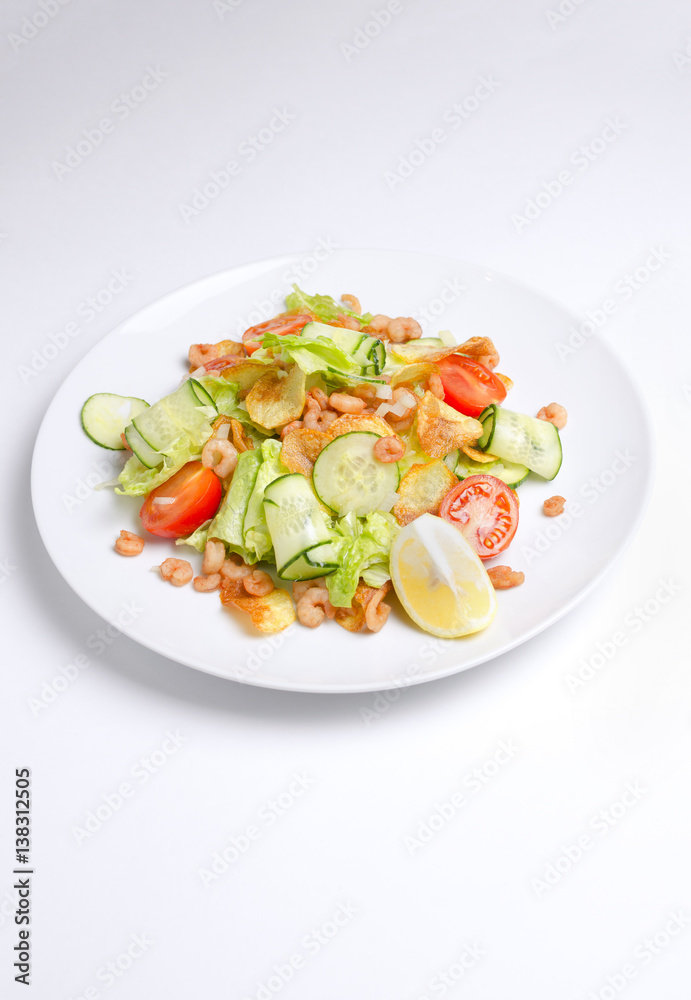 Salad from seafood and vegetables on a white plate Salad from seafood and vegetables on a white plate