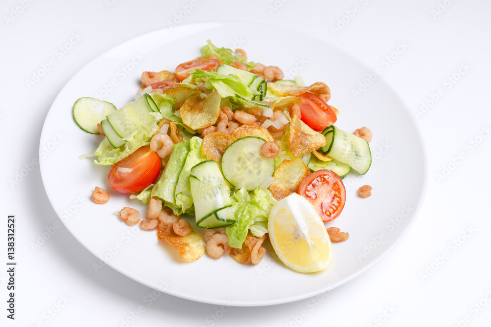 Salad from seafood and vegetables on a white plate Salad from seafood and vegetables on a white plate