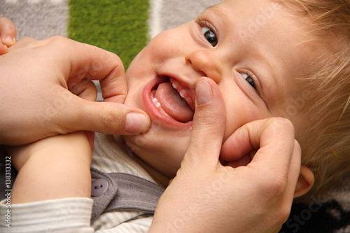 Smiling boy with first deciduous teeth photo