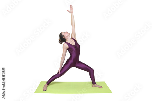 Young slim woman practicing yoga in the studio