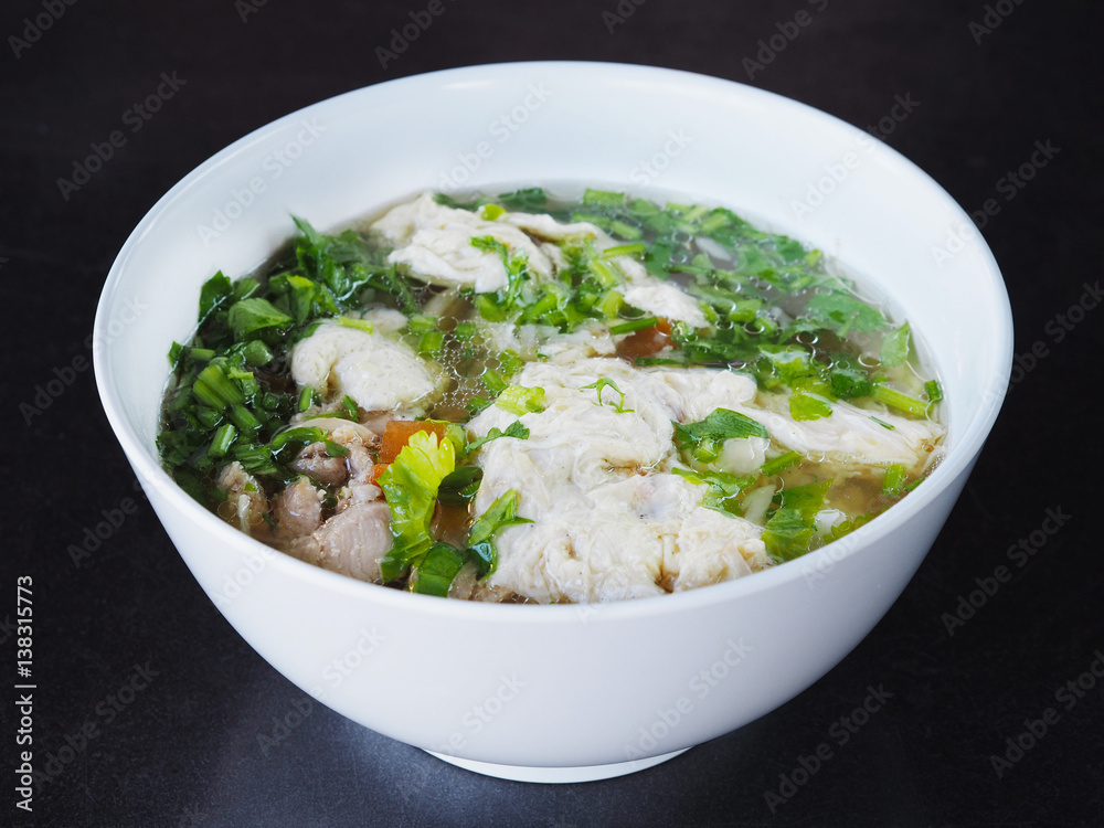 Bowl of soft boiled rice with pork and egg