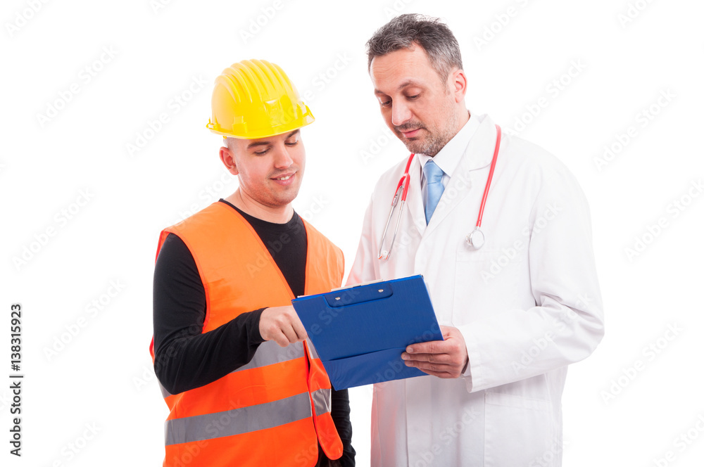 Doctor and constructor looking on blue clipboard Doctor and constructor looking on blue clipboard