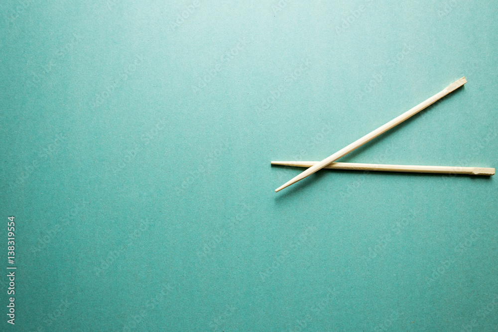 two Chinese chopsticks on the aqua background two Chinese chopsticks on the aqua background