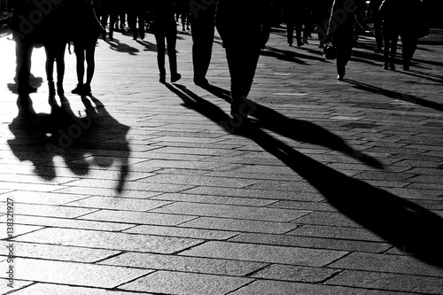 Shadows of people walking in the city