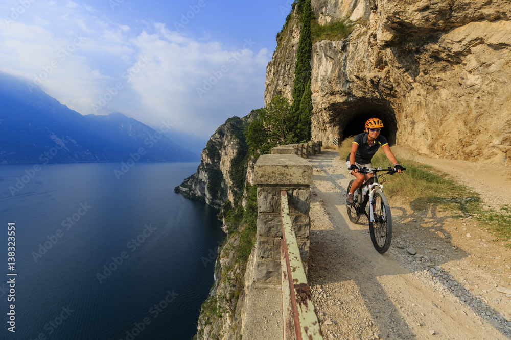 Fototapeta premium Mountain biking on Lake Garda, Sentiero della Ponale, Riva del Garda, Italy