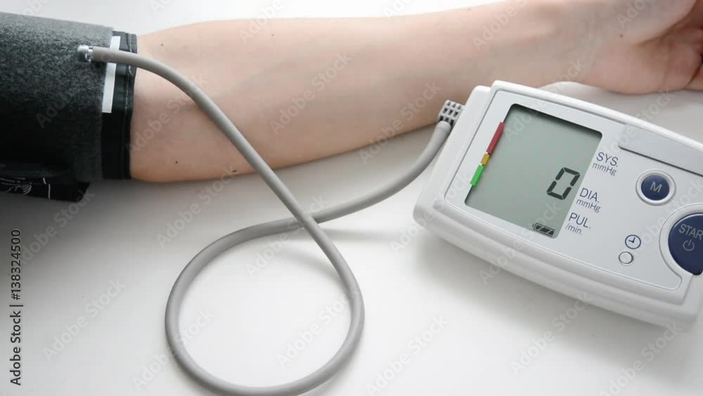 Man measuring his blood pressure and heart-rate Man measuring his blood pressure and heart-rate