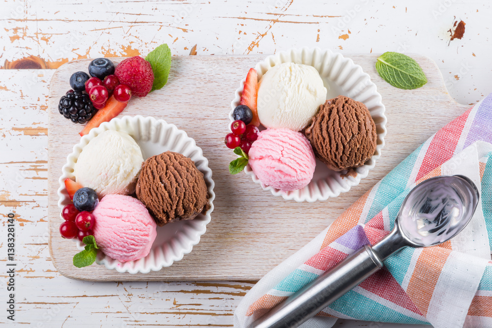 Selection of colorful ice cream scoops in white bowls Selection of colorful ice cream scoops in white bowls