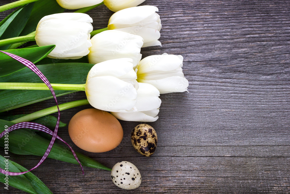 Bouquet white tulip flowers with easter eggs on old wooden table Bouquet white tulip flowers with easter eggs on old wooden table