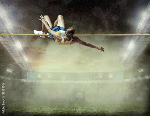 Fototapeta Sportowiec w akcji skoku wzwyż.