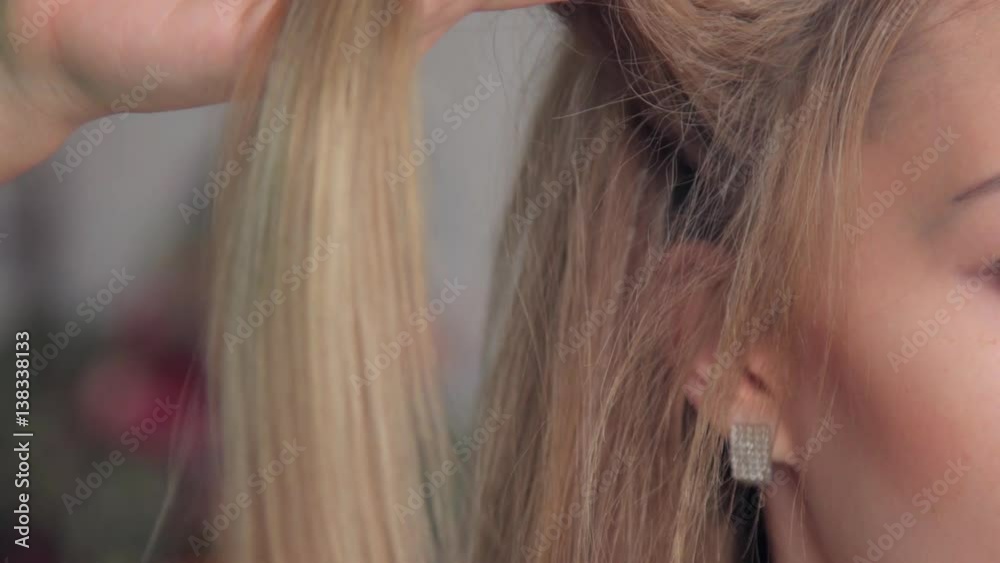 Young woman getting her hair dressed in hair salon. Young woman getting her hair dressed in hair salon.