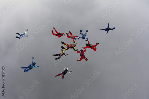 The group of skydivers is in the sky.