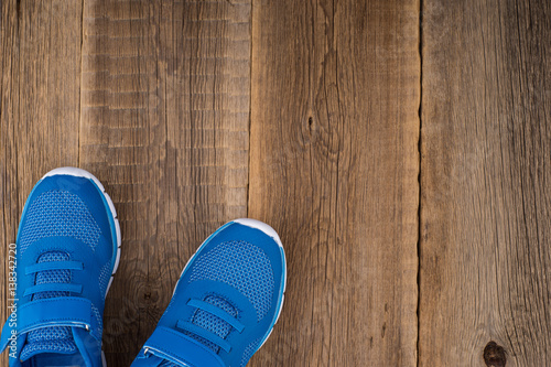 Blue Sneakers with wooden background