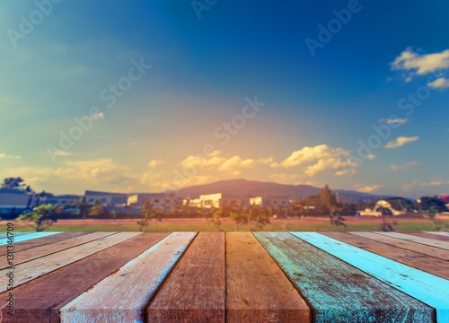 image of wood table and blur house