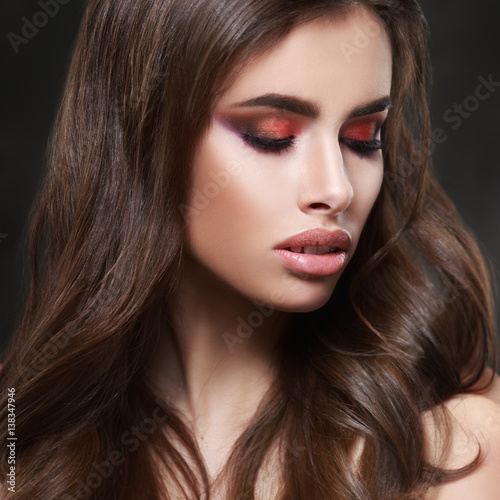 Beauty portrait of sexy elegant woman with bright oriental make-up on a black background.