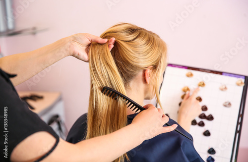 Young blond woman choosing ...