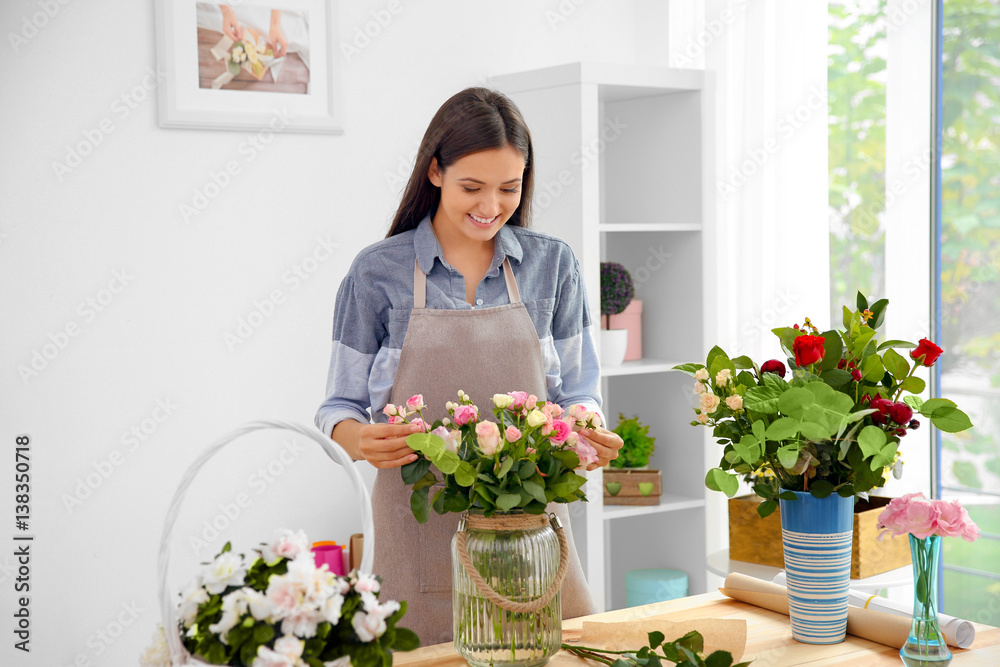 Pretty young florist at workplace