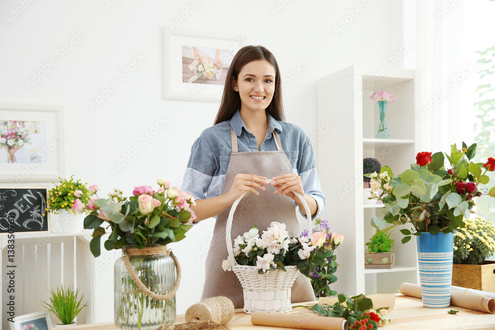 Pretty young florist at workplace