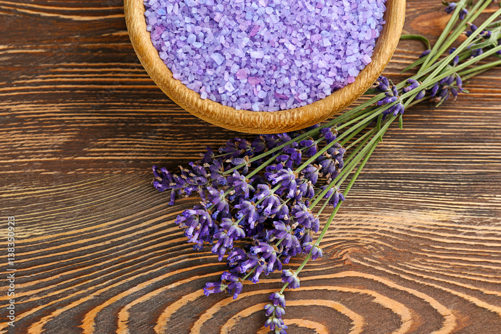 Sea salt with lavender on wooden background Sea salt with lavender on wooden background
