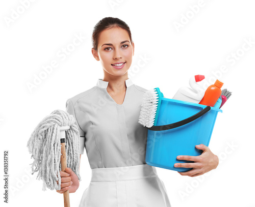 Hotel female chambermaid holding cleaning supplies on white background