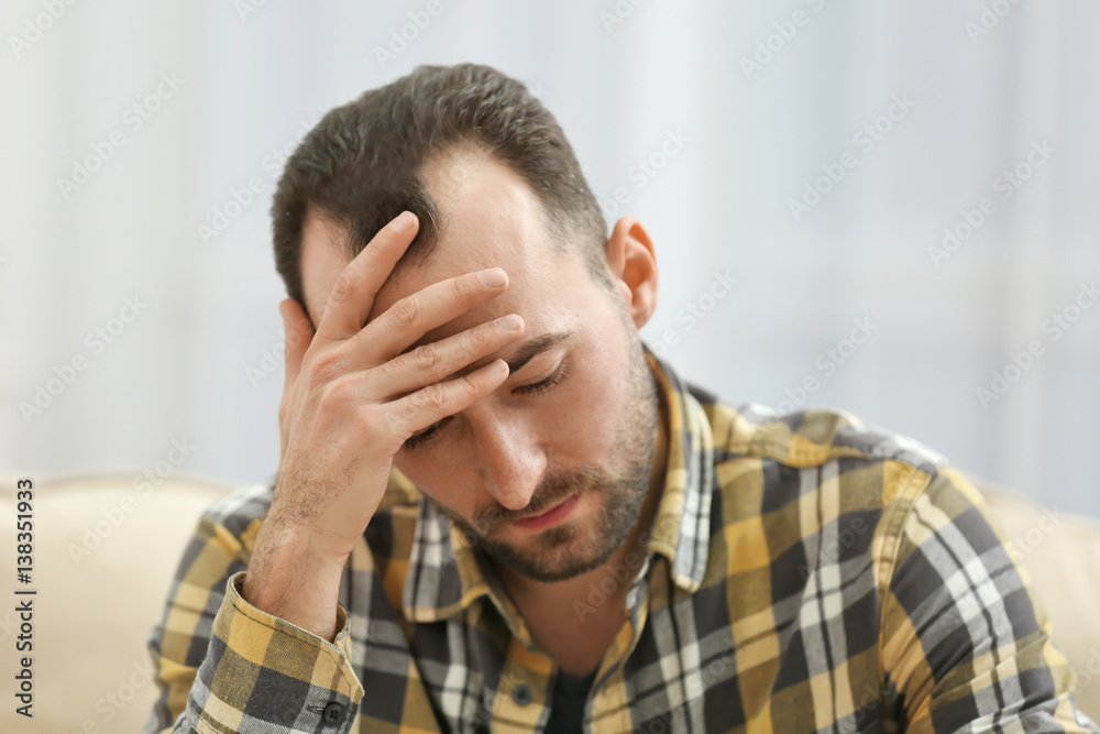 Handsome depressed man at home, closeup Handsome depressed man at home, closeup