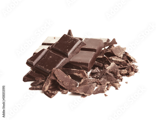 Broken dark chocolate pieces with morsels on white background
