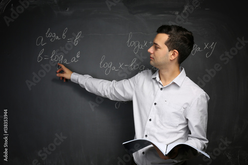 Handsome young teacher expl...
