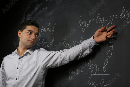Handsome young teacher expl...