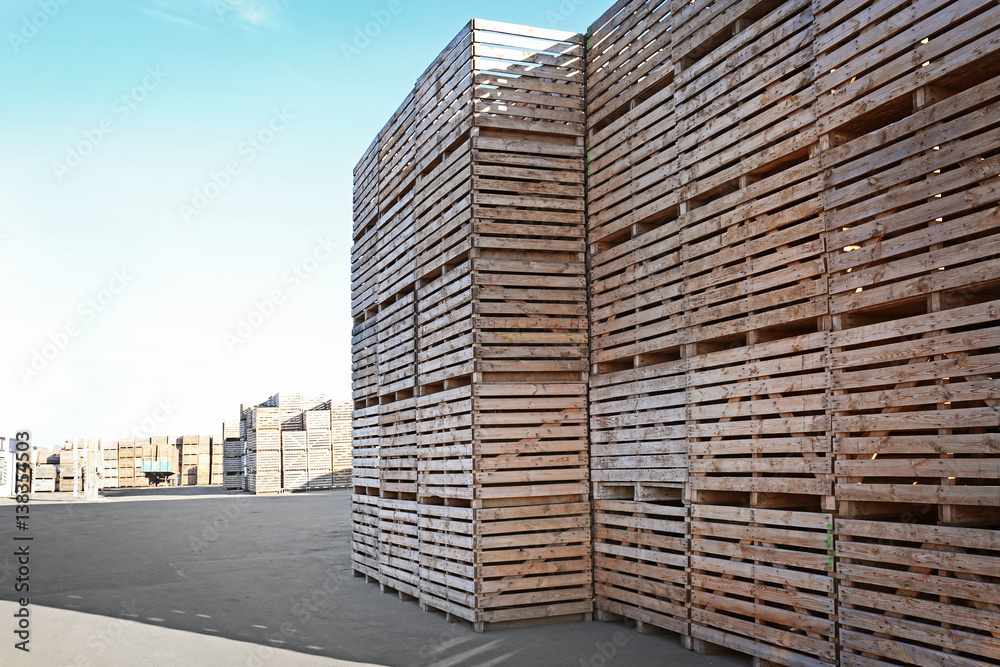 Wooden boxes in open-air warehouse on sunny day Wooden boxes in open-air warehouse on sunny day