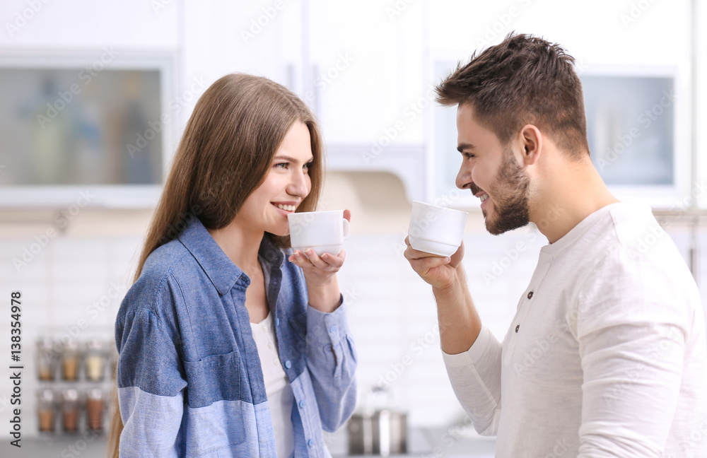 Cute young couple drinking coffee in kitchen Cute young couple drinking coffee in kitchen