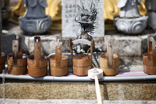 Ritual vessels and wooden bucket for washing hands in a Shinto temple