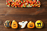 Halloween cookies and jelly sweets on wooden background