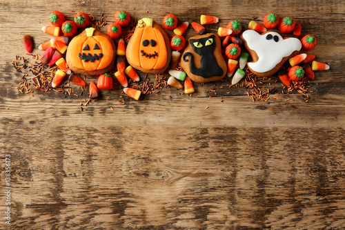 Halloween cookies and jelly sweets on wooden background photo