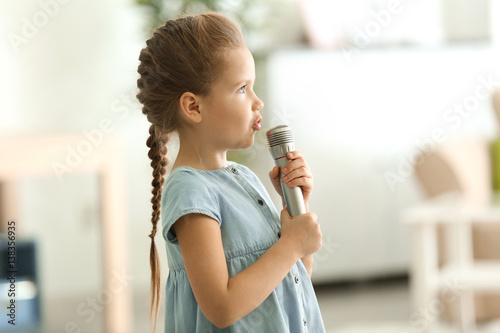 Cute little girl with micro...