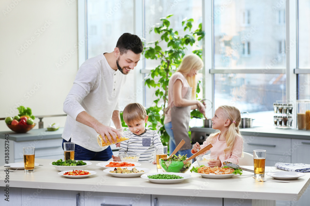 Happy family having breakfast at home