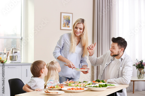 Happy family having breakfa...