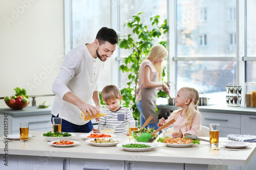 Happy family having breakfast at home