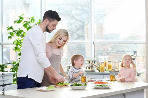 Happy family having breakfa...