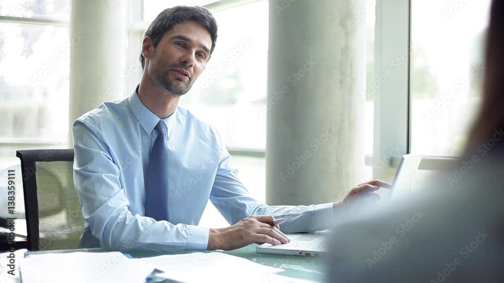 Businessman advising client in office
